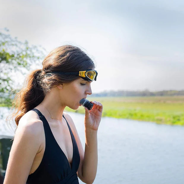 Woman wearing sunglasses with a microphone headset outdoors