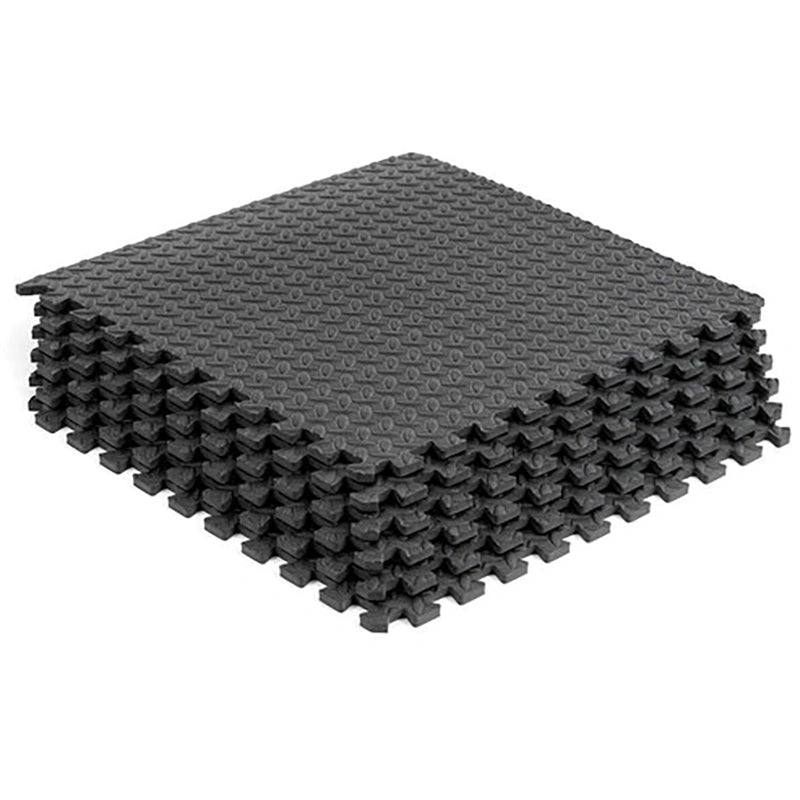 Stack of black interlocking foam mats on a white background