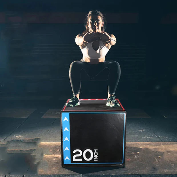 Person performing a jump on a 20-inch box in a gym setting