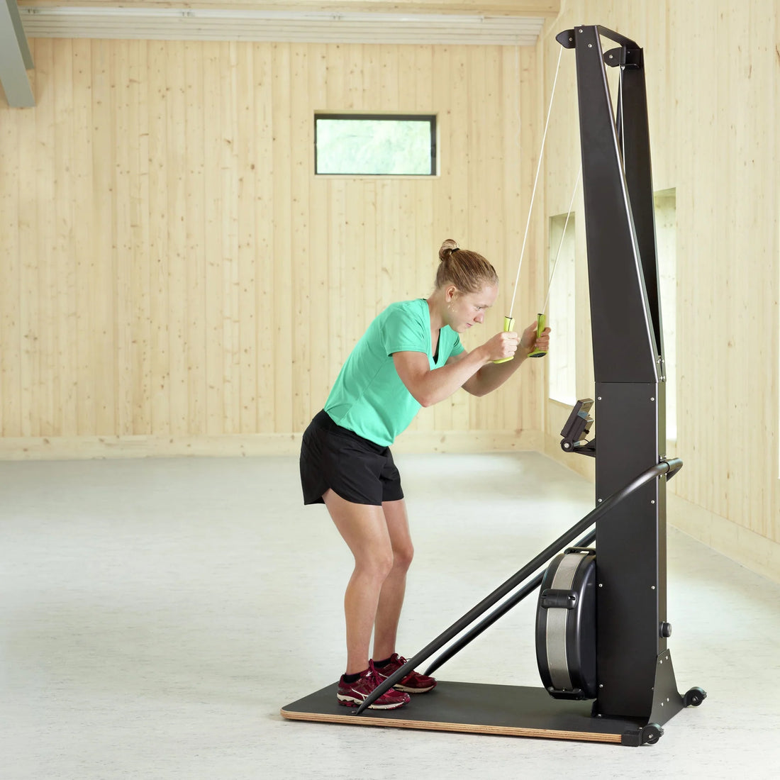 Black rowing machine on a white background