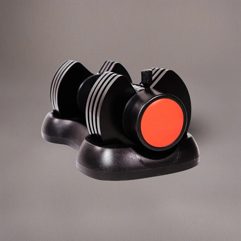 Black and orange dumbbell set on a gray background