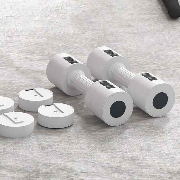 Set of adjustable dumbbells on a gray surface
