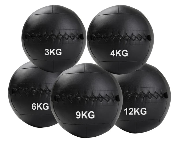 Set of black weighted medicine balls with labeled weights on a white background